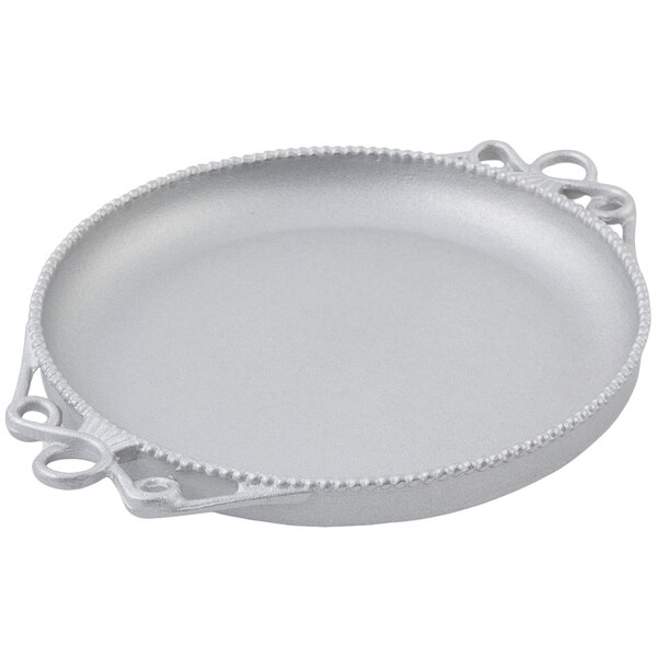 A round silver Bon Chef platter with handles.