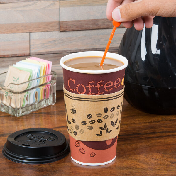 A hand using a Royal Paper Stix To Go orange beverage plug and stirrer to stir coffee in a cup with a lid.