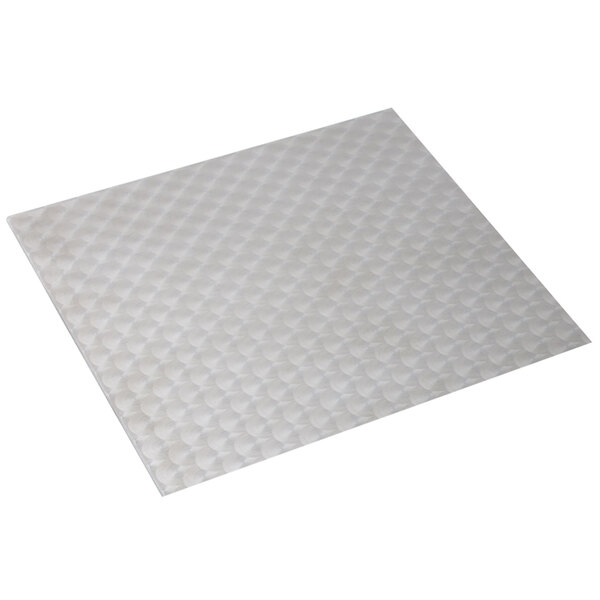 A white square tile with circles on it.