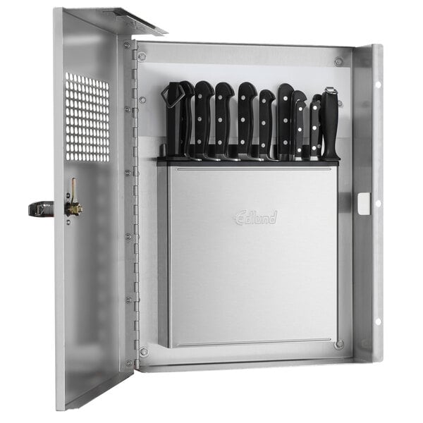 An Edlund silver metal locking knife cabinet with knives inside.