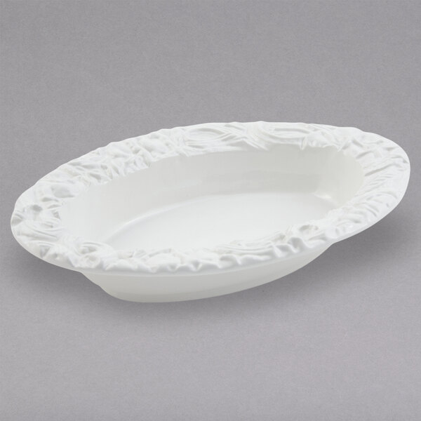 A white oval Bon Chef pasta bowl with a decorative design on it.
