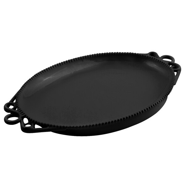 A black oval Bon Chef cast aluminum platter with handles.