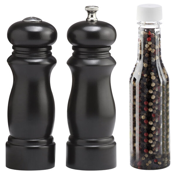 A black pepper mill and salt shaker set on a counter.