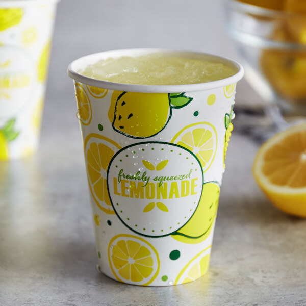 A close-up of a Carnival King lemonade paper cup with lemons on it.