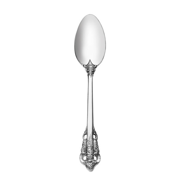 A silver spoon with an ornate design on the handle.