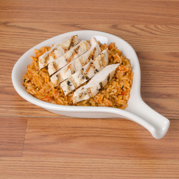 A CAC white fry pan plate with chicken and rice.