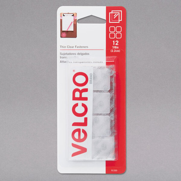 A package of Velcro® clear adhesive fasteners with red and white labels.