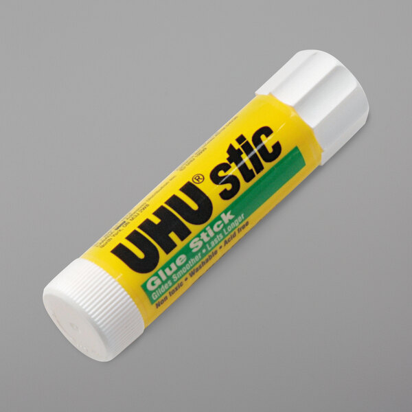 A yellow tube of UHU permanent clear glue with black text on a white background.