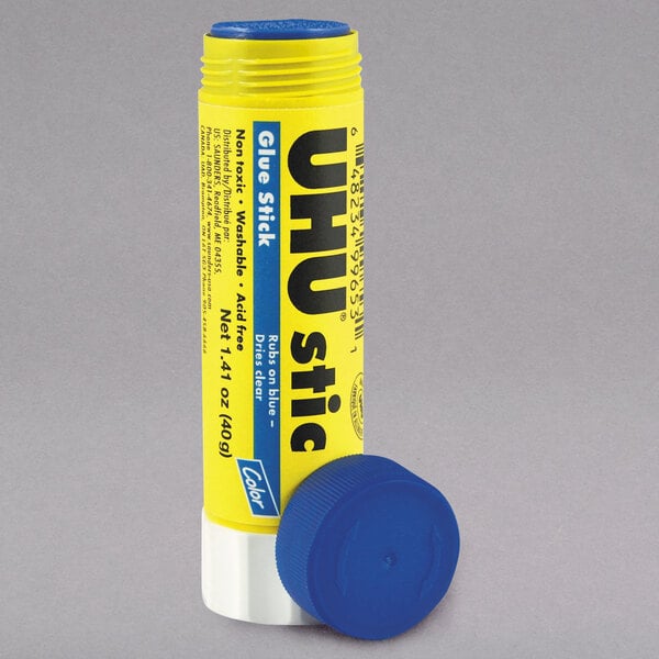 A yellow UHU glue stick with blue caps and a yellow label.