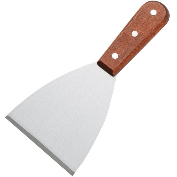 An American Metalcraft grill scraper with a wood handle and a metal blade.