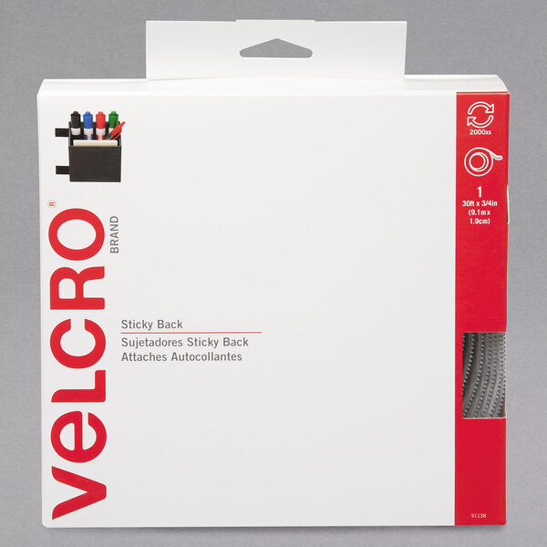 A white box with black and red text and a black and white label for Velcro white sticky-back tape.