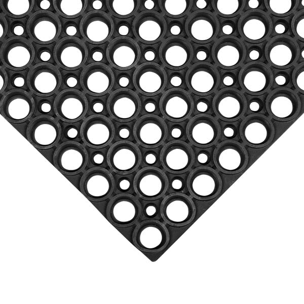 A black rubber mat with holes in circles.