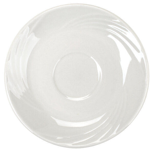 A white CAC porcelain saucer with a swirl design.