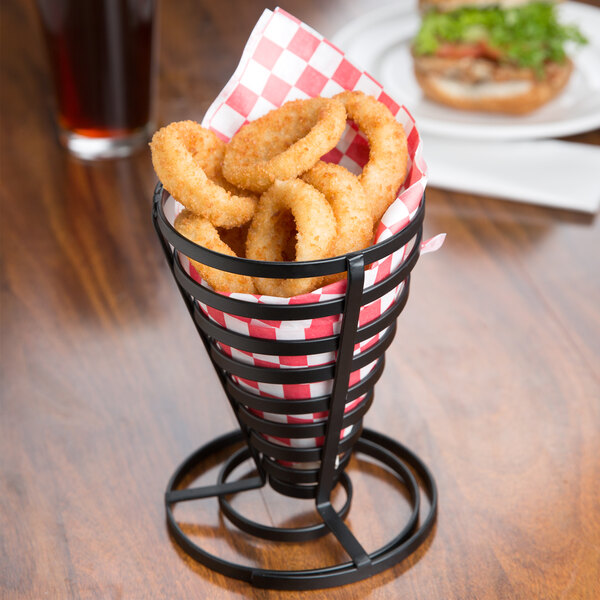 A black wire basket filled with fried onion rings.