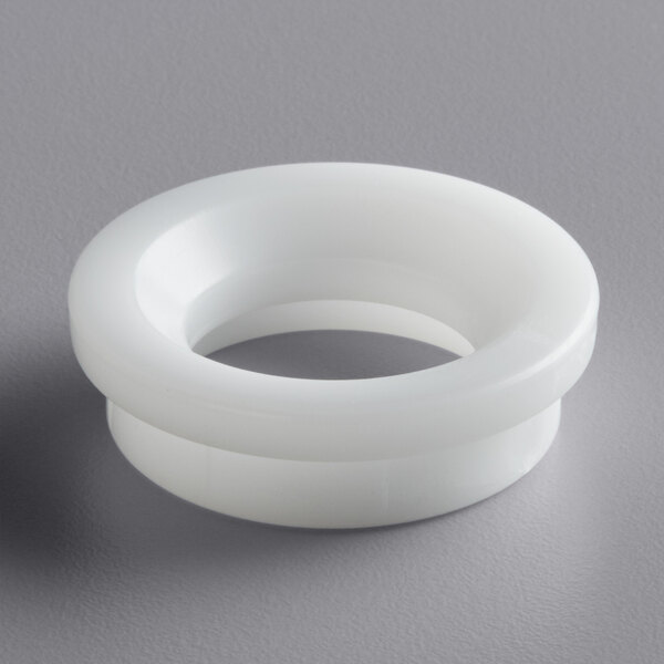 A white plastic front shaft seal with a round hole.