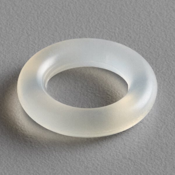 A clear plastic Narvon faucet valve O-ring on a gray surface.