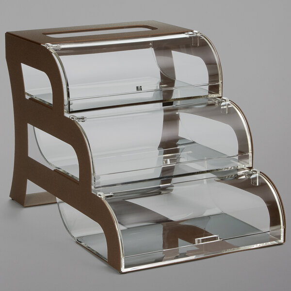 A clear acrylic bakery display case with three shelves on a bronze steel stand.