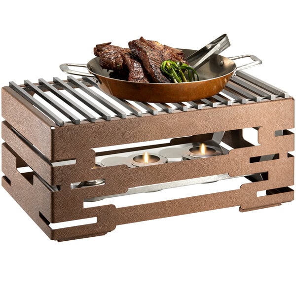 A Rosseto bronze chafer alternative grill top with meat and vegetables cooking on it.