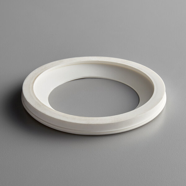 A white plastic bowl gasket with a hole in the center.
