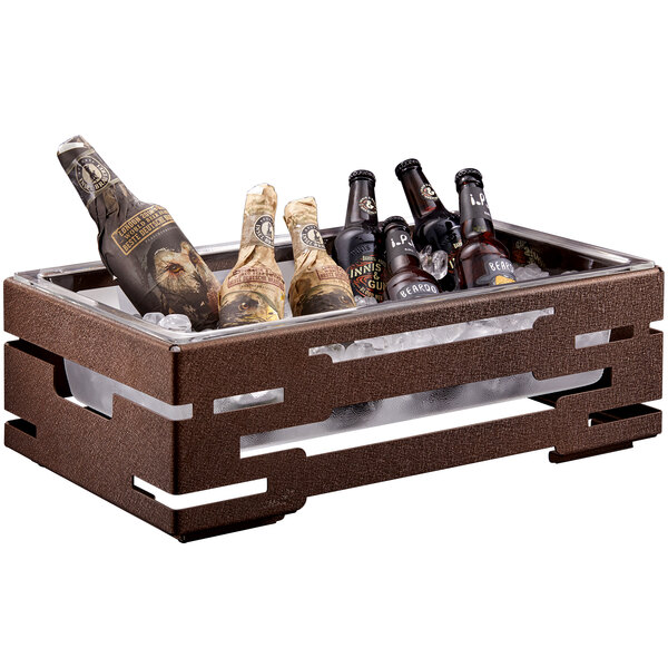 A brown steel ice housing with clear acrylic insert holding bottles of beer and wine.