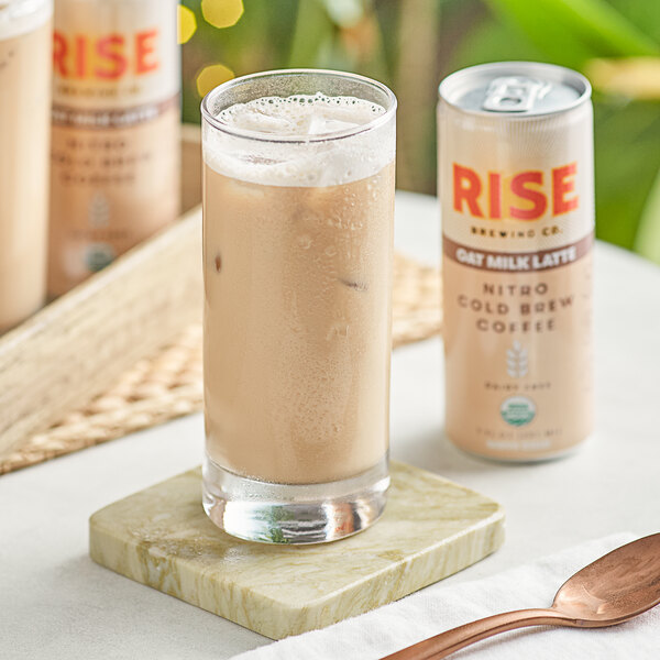 A glass of Rise Brewing Co. Organic Oat Milk Latte Nitro Cold Brew Coffee on a marble coaster.