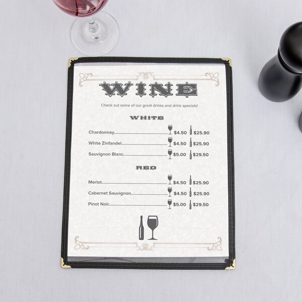 A tan swirl border menu on a table with wine glasses.