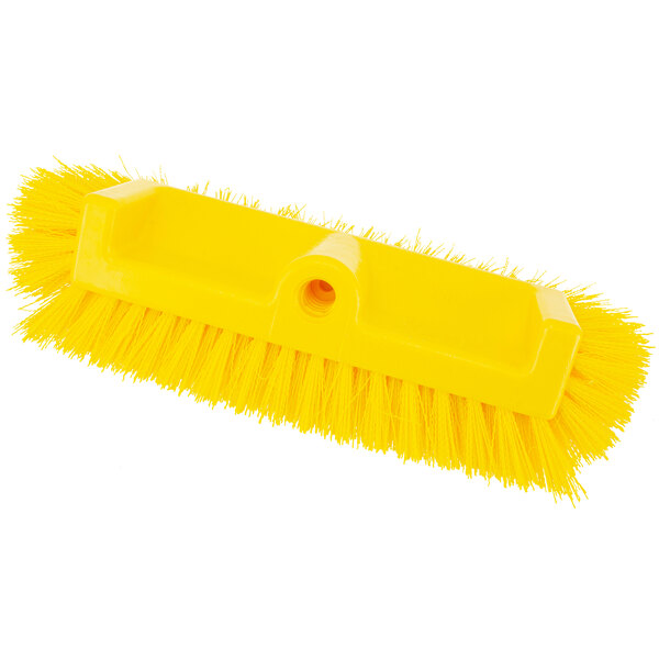 A Carlisle yellow floor scrub brush with end bristles.