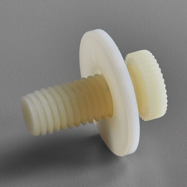 A yellow and white plastic screw with a white disc on it.