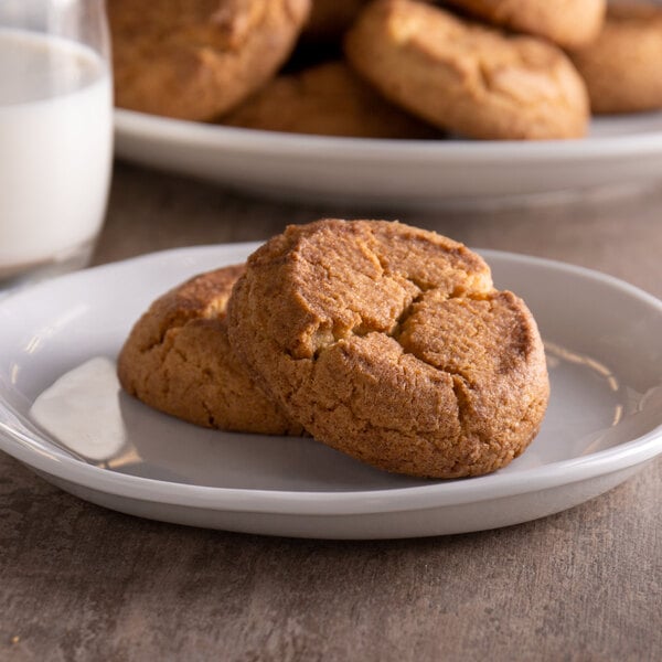 A plate of David's Cookies gluten-free snickerdoodle cookies with a glass of milk.