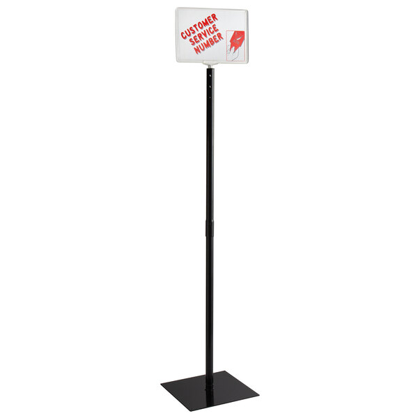 A black sign on a Garvey black display stand pole.