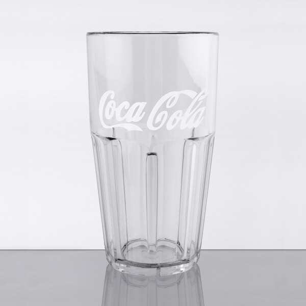 A close-up of a clear plastic tumbler with the Coca-Cola logo.