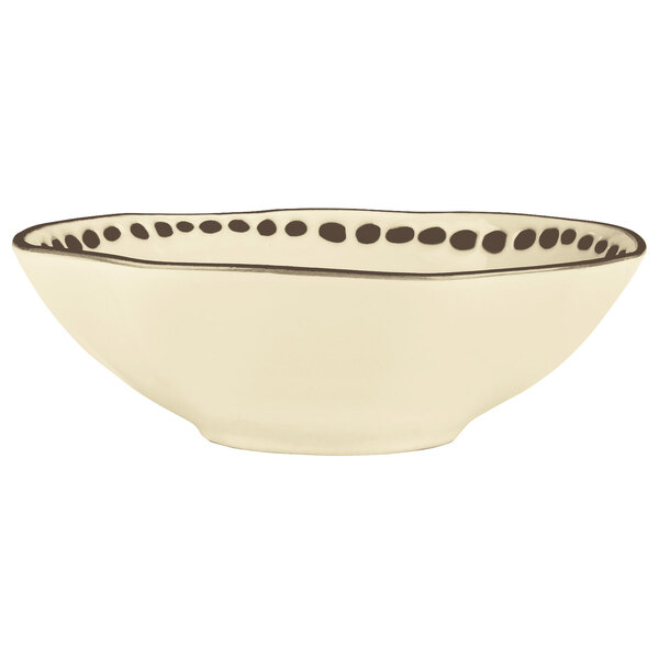 A white stoneware bowl with black dots.