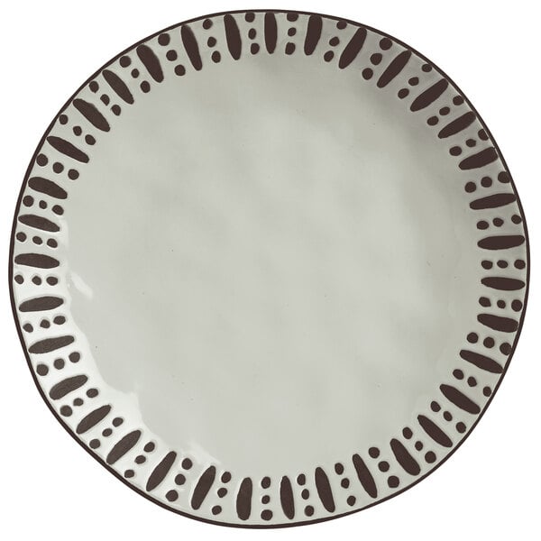 A white Libbey stoneware dinner plate with black dots on it.