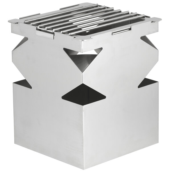 A stainless steel cube with a grate and fuel shelf on four legs.