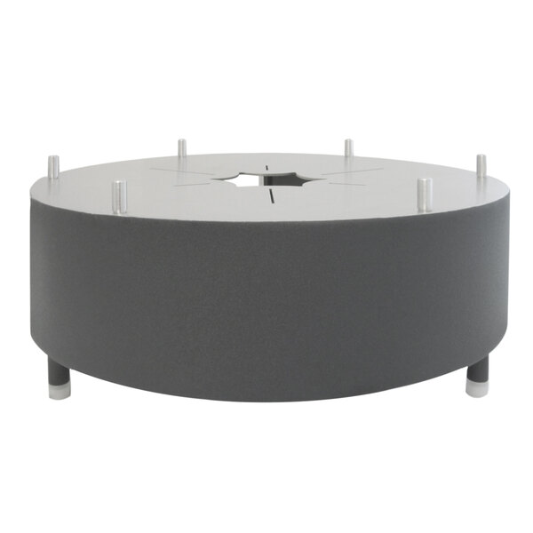 A round stainless steel chafer alternative with a hole in the middle on a table.