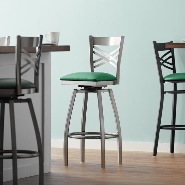Lancaster Table & Seating Clear Coat Finish Cross Back Swivel Bar Stool with 2 1/2" Green Vinyl Padded Seat