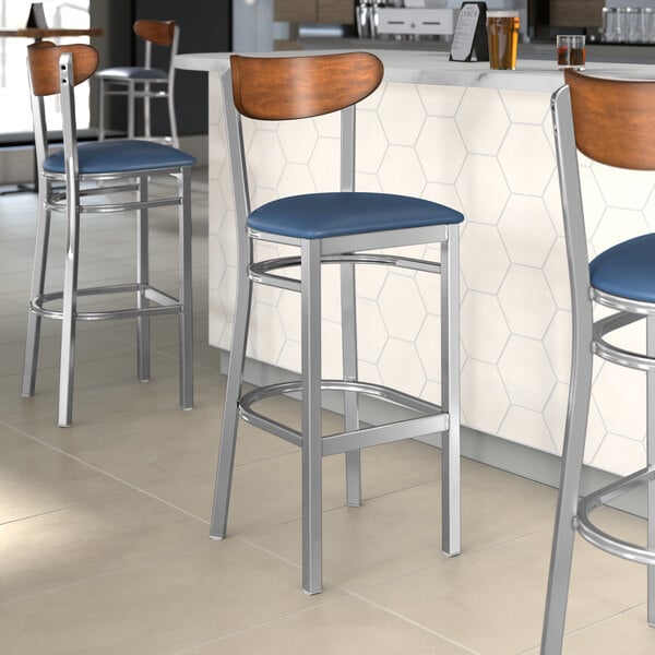 Lancaster Table & Seating bar stools with navy vinyl seats.