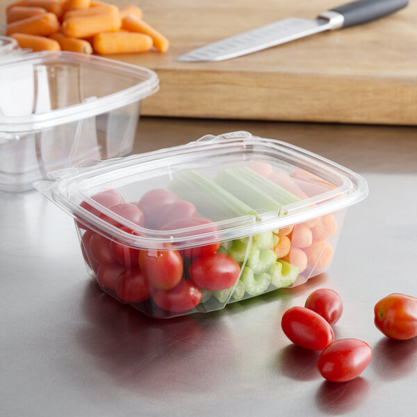 A Dart ClearPac plastic container filled with vegetables with a flat lid.