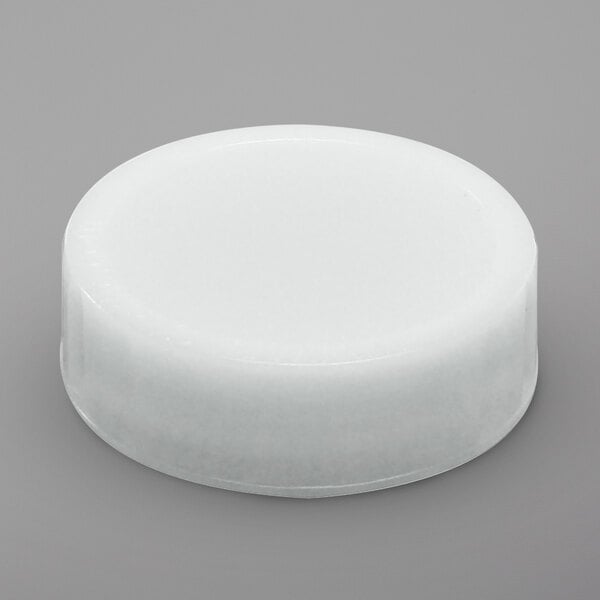 A white round plastic FIFO label cap.