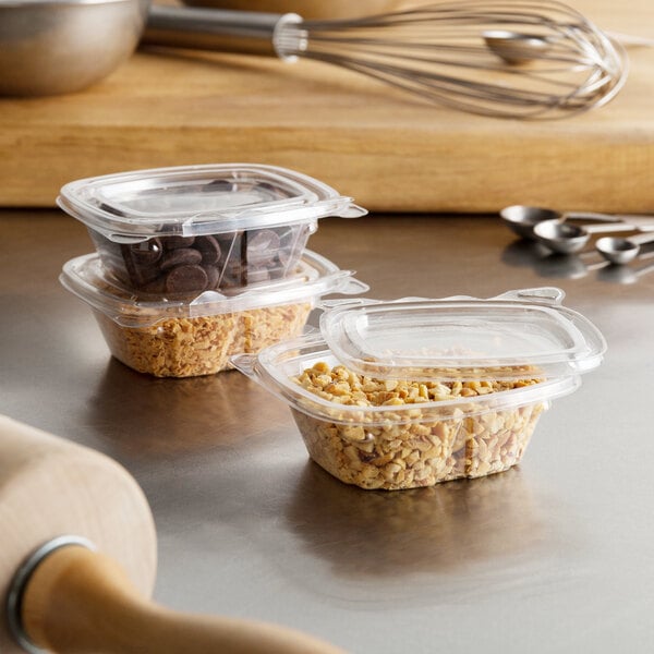 A Dart ClearPac plastic deli container with cereal in it on a table.