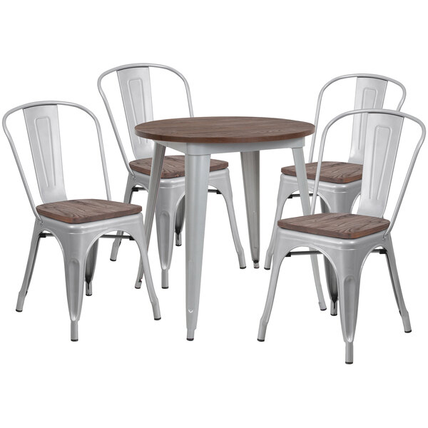 A round galvanized steel and wood table with three wooden chairs around it.