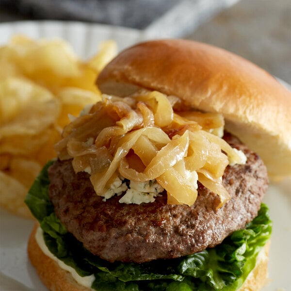 A burger with Savor Imports caramelized onions and cheese on a plate.