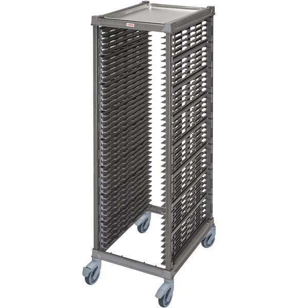 A Cambro metal sheet pan rack with plastic casters holding trays.