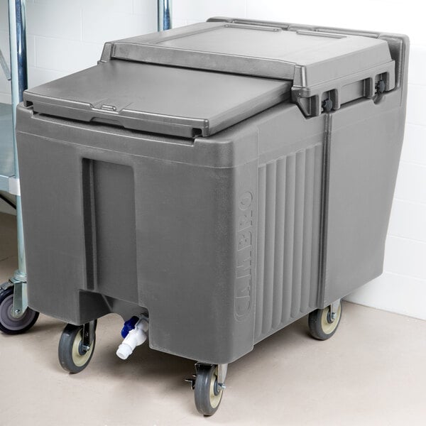 A grey plastic Cambro mobile ice bin with wheels.