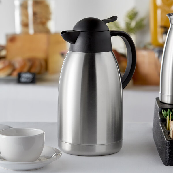 A silver and black Choice insulated thermal coffee carafe on a white table.