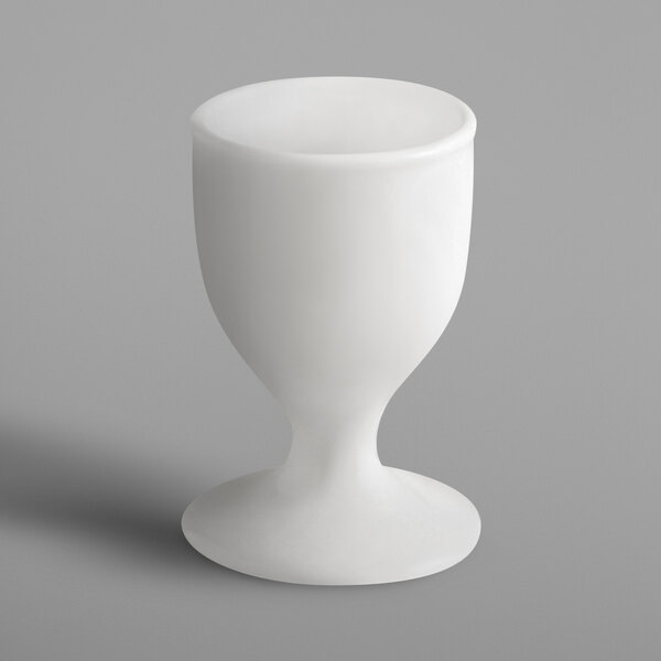 A white porcelain egg cup with a white base.