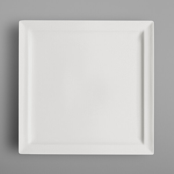 A RAK Porcelain ivory square plate on a gray surface.