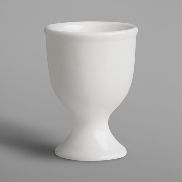 A RAK Porcelain ivory egg cup on a gray surface.
