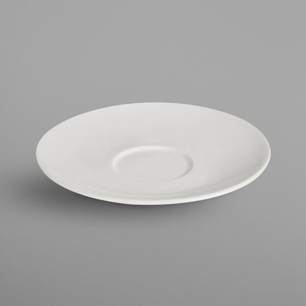 A RAK Porcelain ivory porcelain saucer with a circular edge.