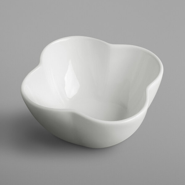 A white bowl with a flower design on it.